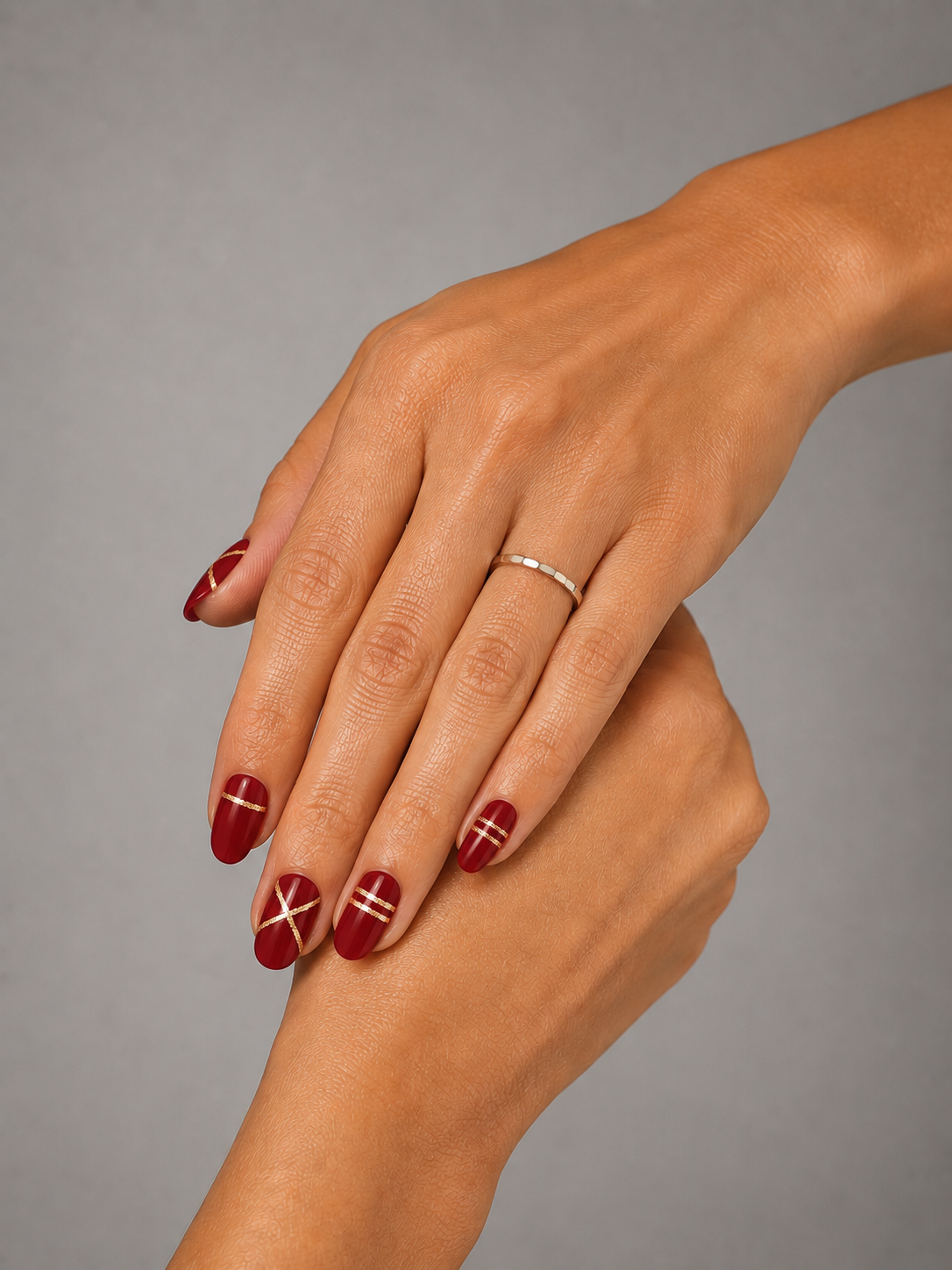 Main aux autocollants vernis rouges et dorés