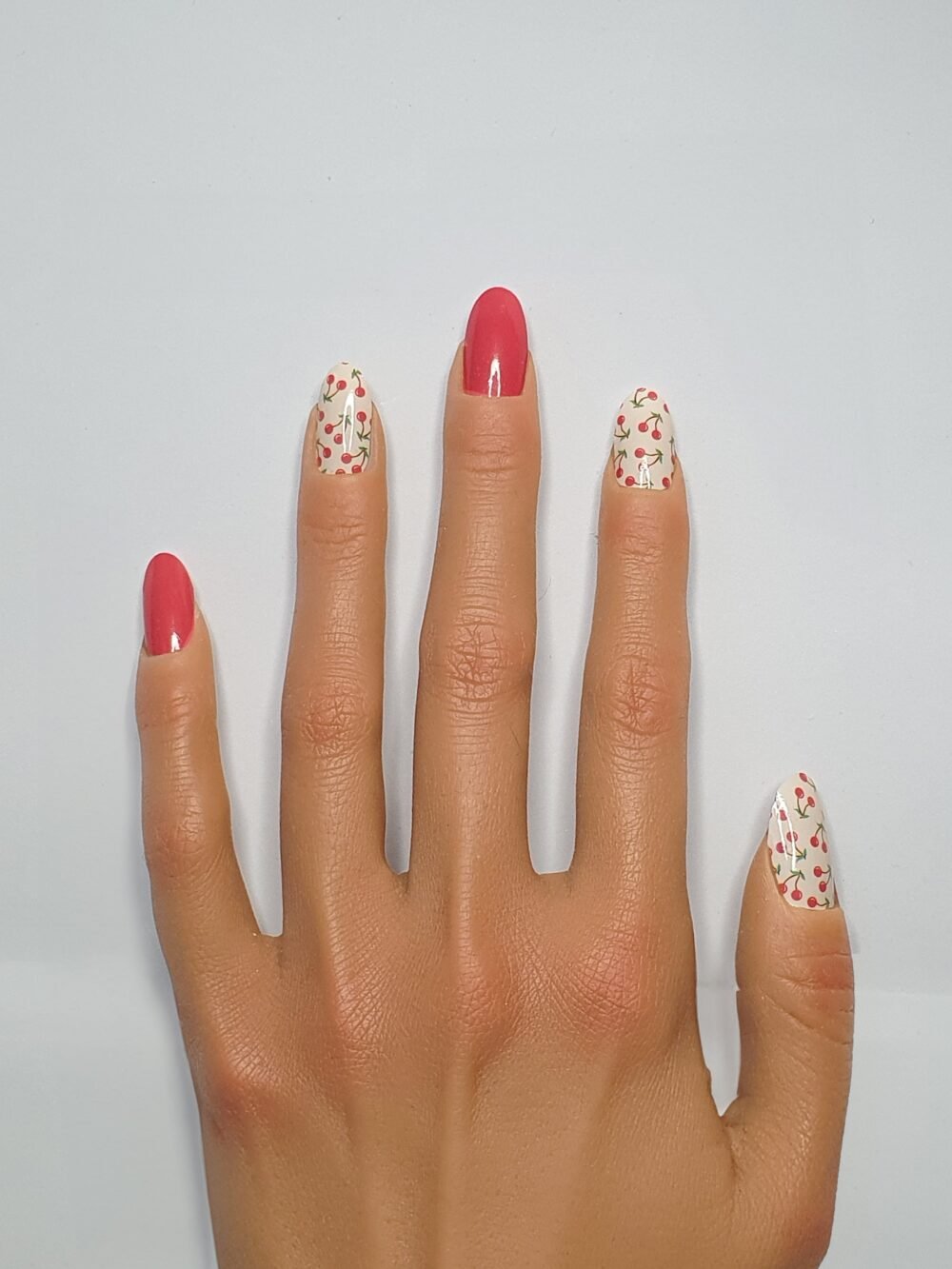 Une mains aux ongles cerise
